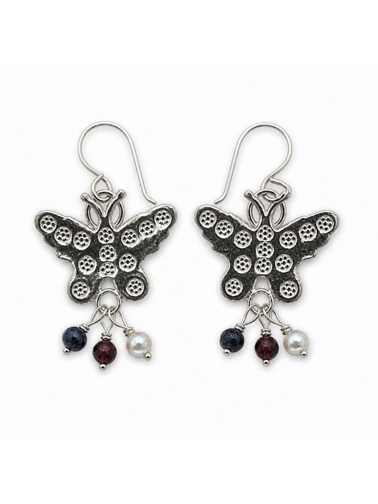 A pair of silver butterfly drop earrings with textured wings and dangling charms including dark blue, burgundy, and white beads, shown on a plain white background.