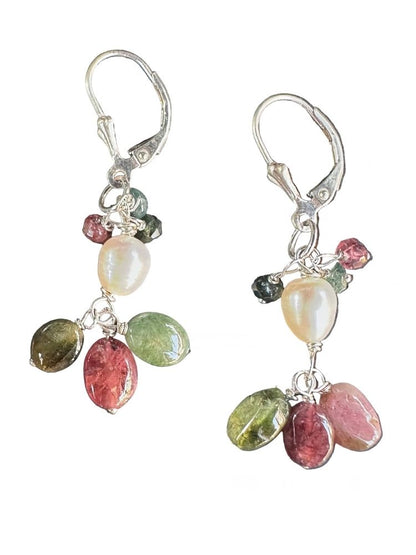 A pair of silver leverback dangle earrings featuring a white freshwater pearl and multiple faceted gemstones in pink, green, and olive, set against a plain white background.
