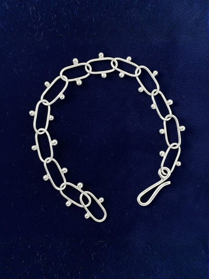 silver_bracelet_with_oval_links_and_bead_details